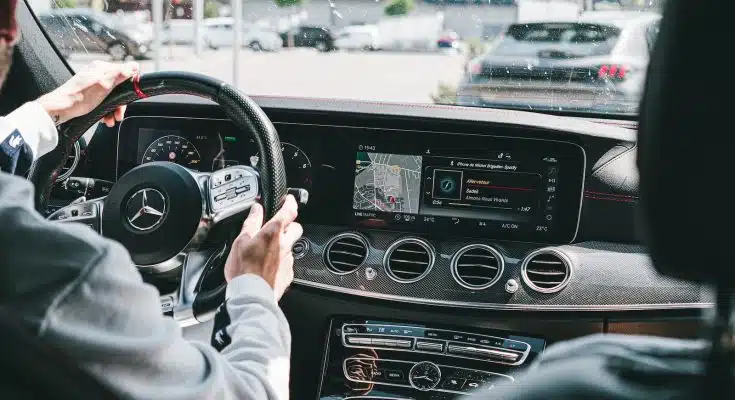 person in gray long sleeve shirt driving car