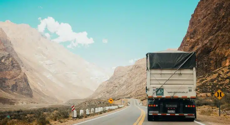 white and black truck near mountain at daytime