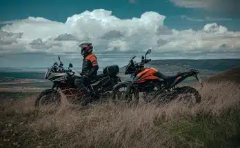 man riding on red and black sports bike